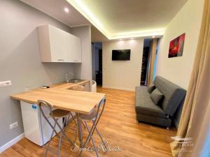 a kitchen and living room with a table and a couch at b&b Stadium room & suite in Crotone