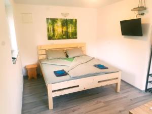 a bedroom with a bed with a wooden bed frame at GreenRiver Apartment in Spodnje Gorje