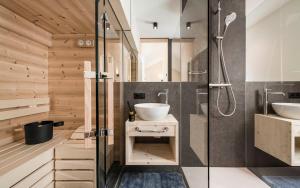 a bathroom with two sinks and a shower at Stadl Chalet oberhalb Brixen in Rosa