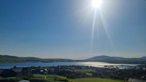 a view of a river with the sun in the sky at Fab View in Dingle