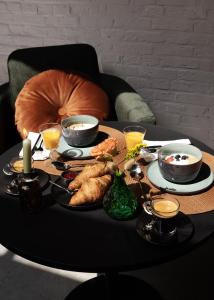 a table with breakfast foods and drinks on it at Cousins Boutique Hotel in Maastricht