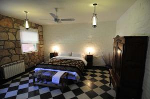 a bedroom with a bed and a stone wall at La Aguada Hotel Boutique de Montana in Coneta