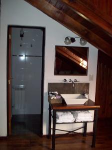 a bathroom with a sink and a mirror at La Aguada Hotel Boutique de Montana in Coneta