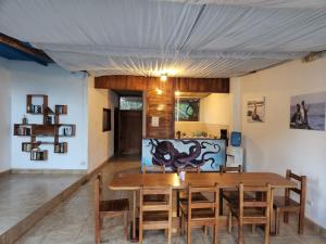 a dining room with a wooden table and chairs at Hotel La Jungla in Puerto Villamil