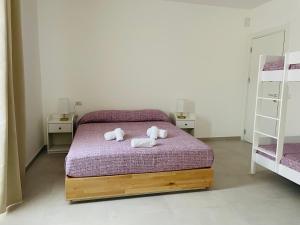 Postel nebo postele na pokoji v ubytování B&B S'arciaredda