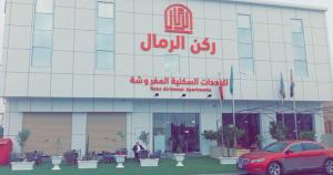 a red car parked in front of a building at ركن الرمال in Sakakah