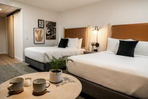 a hotel room with two beds and a table at Forest Park Hotel in Jasper