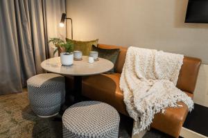 a living room with a table and two chairs at Forest Park Hotel in Jasper