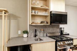 a kitchen with a sink and a stove top oven at Forest Park Hotel in Jasper