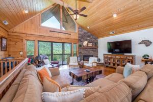 a large living room with a couch and a table at Wild Valley Lodge-Log Cabin in Lake Lure, NC, Close to Chimney Rock - Stunning Views in Lake Lure