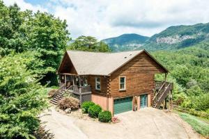a log home with a porch and a garage at Wild Valley Lodge-Log Cabin in Lake Lure, NC, Close to Chimney Rock - Stunning Views in Lake Lure
