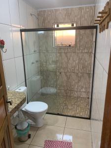 a bathroom with a shower and a toilet at Casa Araucária in Visconde De Maua +20 photos
