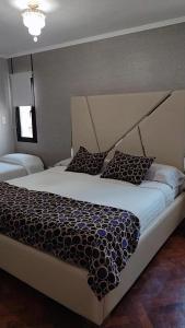 a bedroom with a large bed with a large headboard at Like at Home Ezeiza in Ezeiza