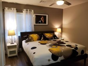 a bedroom with a bed with a black and yellow comforter at A - Fully remodeled and professionally decorated in Las Vegas