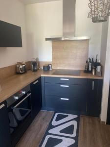 a kitchen with a counter with a stove top oven at Petit cocon douillet avec terrasse in La Rochelle