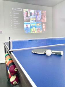 a blue ping pong table with a ball on it at Caithness Holiday Home in Pontypool