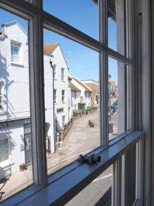 an open window with a view of a street at luxury 3 bathroom cinema and sauna in Seaford