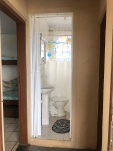 a bathroom with a toilet and a sink at Pé na areia in Ilha Comprida