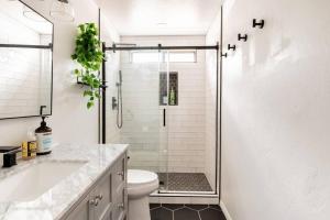 a bathroom with a shower with a toilet and a sink at EVERGREEN LODGE+SKI in Sugarloaf