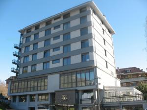 a tall white building with a lot of windows at Park Hotel Sporting in Teramo