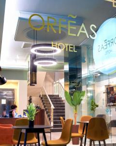 a store with chairs and tables and a staircase at Hotel Orfeas in Xanthi