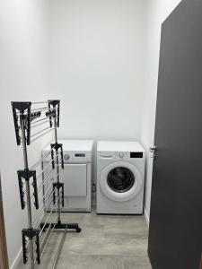 een wasruimte met een wasmachine en een wasmachine bij Loft épuré avec parking privé. in Saint-Symphorien-dʼOzon