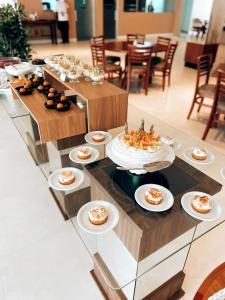 a buffet with cakes and desserts on a table at Resort Ecoar in Gaspar