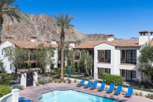 a resort with a swimming pool and palm trees at Legacy Villas private 3 bedroom 3 bath villa with view, steps to pool, bikes and arcade game included in La Quinta
