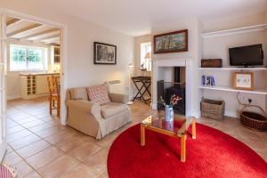a living room with a couch and a coffee table at No. 4 Back Lane - Norfolk Cottage Agency in Burnham Market