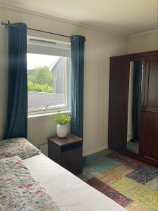 a bedroom with a bed and a large window at private room in shared apartment in Trondheim