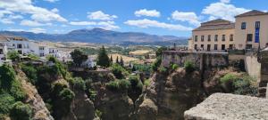 a view of a town on a mountain with buildings at Apartamento Catalina, en el casco histórico. in Ronda