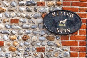 a sign that says meadow bar on a brick wall at Meadow Barn - Norfolk Cottage Agency in North Walsham