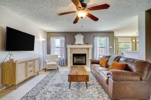 a living room with a leather couch and a fireplace at Brickhouse Retreat in Round Rock