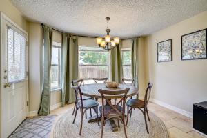 a dining room with a table and chairs and windows at Brickhouse Retreat in Round Rock