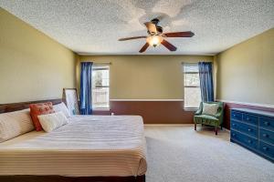a bedroom with a bed and a ceiling fan at Brickhouse Retreat in Round Rock