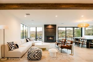 a living room with a couch and a table at Amaru Muru - Luxury Retreat with Pool/Hot Tub/Yoga in Joshua Tree
