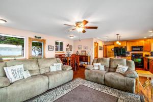 a living room with two couches and a kitchen at The Cozy Crabshack in Brinnon