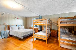 a bedroom with two bunk beds and a bed at The Cozy Crabshack in Brinnon