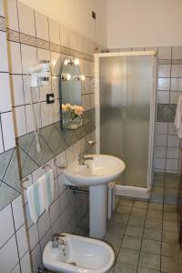 a bathroom with a sink and a shower and a toilet at Hotel Nespolo D'Oro in Lariano