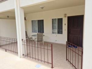 a balcony with a table and chairs in a house at Hermosa Paradise in Playa Hermosa