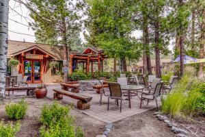 a patio with a table and chairs in front of a cabin at Alpine Escape in Bend