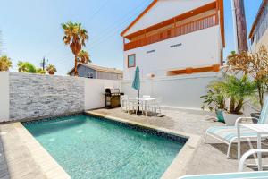 a swimming pool in the backyard of a house at Dolphin Paradise Unit A in South Padre Island