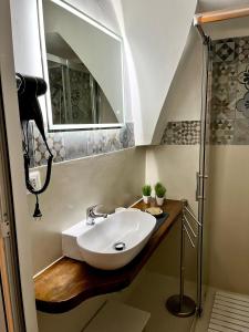 a bathroom with a sink and a mirror at Tama67 suite in Ostuni