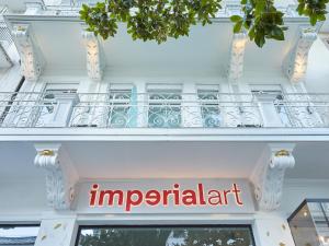 a building with a sign for an imperial apartment at Boutique Hotel Imperialart in Merano