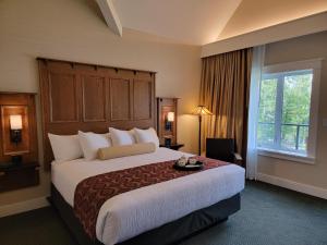a hotel room with a large bed and a window at Kilmorey Lodge in Waterton Park