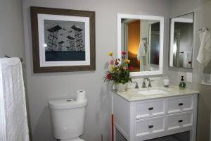 a bathroom with a toilet and a sink and a mirror at T-Designed to ENJOY!. Best Vacation in Las Vegas