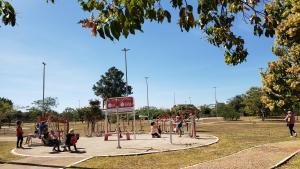 a group of children playing on a playground in a park at Descanse na rede da varanda em um local nota 10 e Wi Fi top! in Brasilia