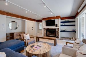 a living room with a blue couch and a fireplace at Teewinot C2 in Teton Village