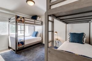 a bedroom with two bunk beds and a window at Teewinot C2 in Teton Village