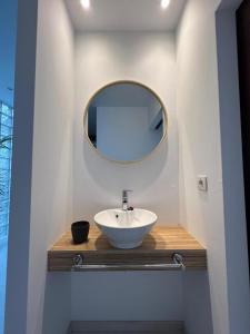 a bathroom with a sink and a mirror at BALCÓN DO MARIÑEIRO in Burela de Cabo
